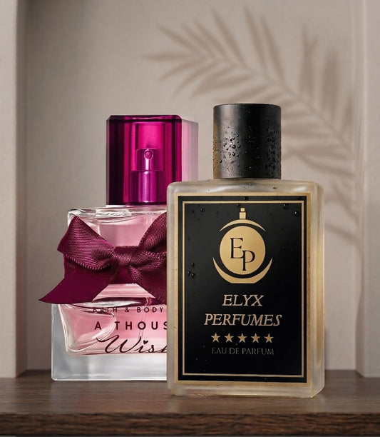 Two perfume bottles, one pink and one gold with 'Elyx Perfumes' branding, on a wooden surface.